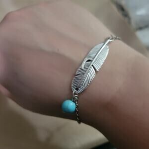Boho feather charm bracelet with synthetic turquoise bead accent